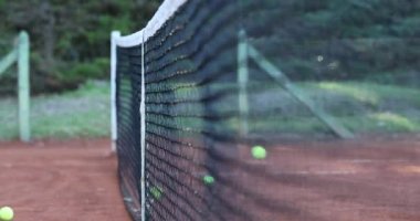 Ball hitting tennis court net
