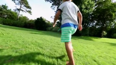 Boy toddler running in home garden outdoors