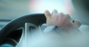 Hand holding steering wheel driving