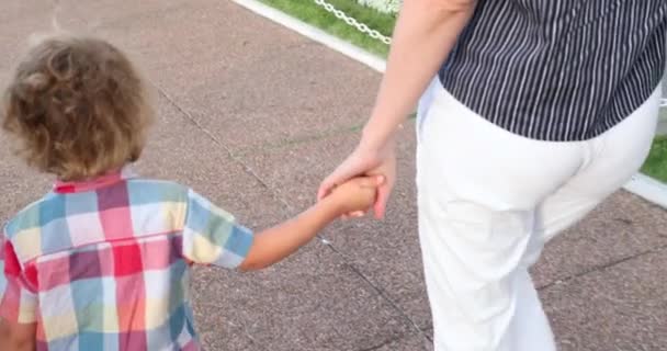 Child Holding Mom Hand Walking — Stock video