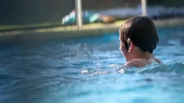Kid going underwater. Young boy at the pool
