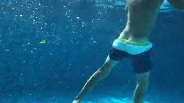 Child legs underwater pretending to be drowning