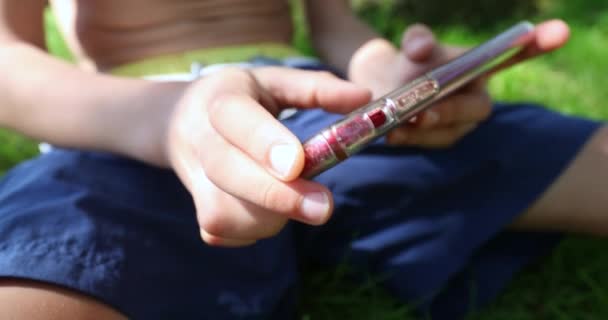 Blonde Boy Playing Games Cellphone Outdoors — Stock video