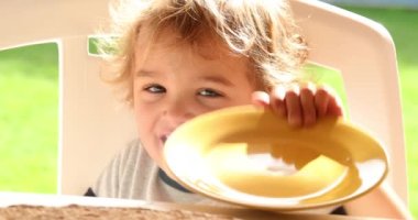 Bashful shy little boy toddler hiding from camera