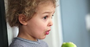 Child eating green apple fruit