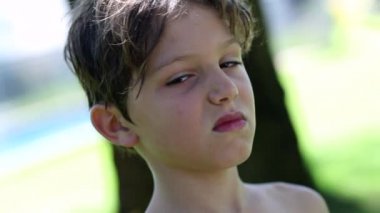 Child boy sticking tongue out
