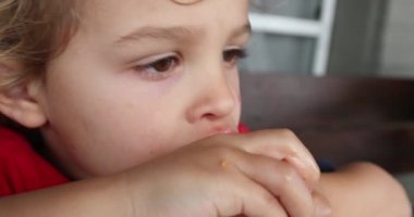 Child eating melon, close-up view
