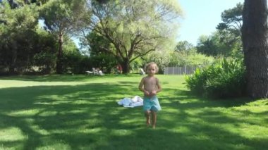 Toddler baby boy at home lawn