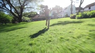 Çocuk dışarı koşuyor ve havuz suyunun içine dalıyor.