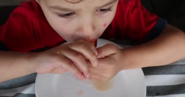 Child toddler boy eating melon fruit