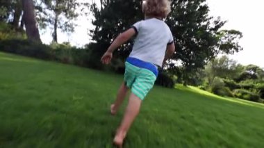 Toddler boy running outside