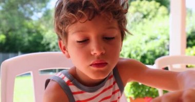 Child boy eating crepe in the morning breakfast