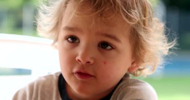 Portrait of cute blonde baby boy, candid and authentic expression