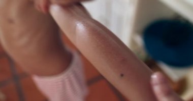 Applying sunscreen lotion to child boy arm