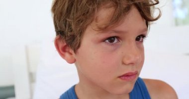 Angry upset child boy pushing camera away