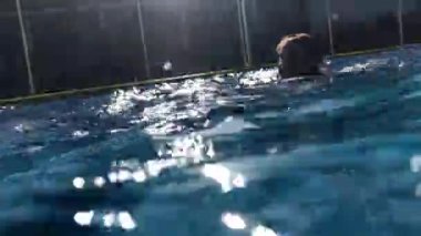 Young boy underwater at the pool