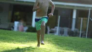 Kid running outdoors in home garden