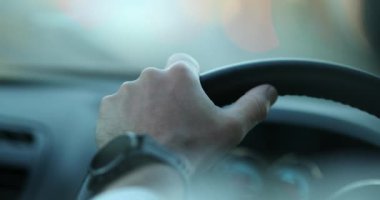 Hand holding steering wheel driving