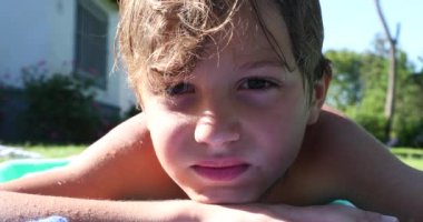 Yakışıklı çocuk kameraya bakıyor.