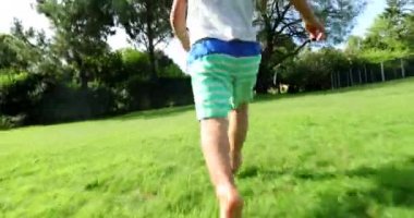 Toddler child boy running outdoors in home garden