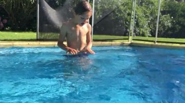 Child taking deep breath at the swimming pool, resting