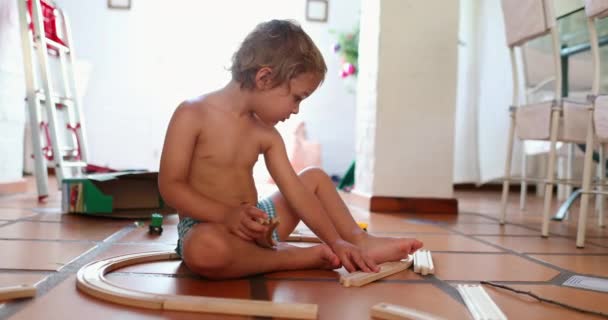 Toddler Playing Indoors Toys Putting Road Pieces Together — Stockvideo