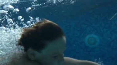 Child diving underwater in super slow-motion 240fps