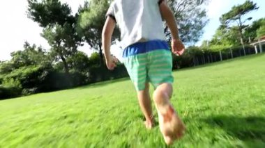 Happy infant running outside in home garden