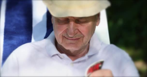 Older Man Reading Outdoors Retired Senior Person — Stockvideo