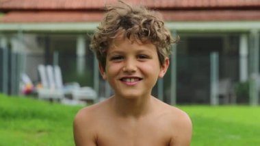 Portrait of happy handsome child boy looking to camera smiling