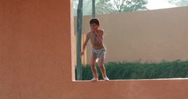 child boy jumping inside swimming pool