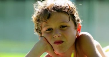 Little boy smiling to camera outside