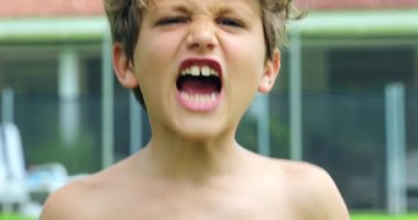 Child face screaming from top of his lung in slow-motion