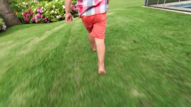 Toddler running in home garden outside
