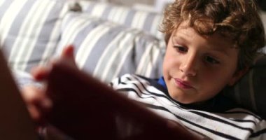 Little boy using cellphone device playing video-games