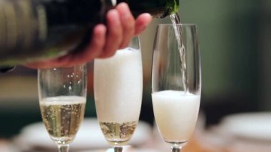 Closeup serving champagne in 120fps slow-motion