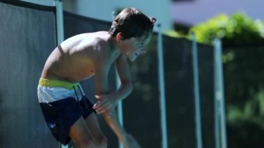 Child boy having fun at swimming pool. young boy by poolside