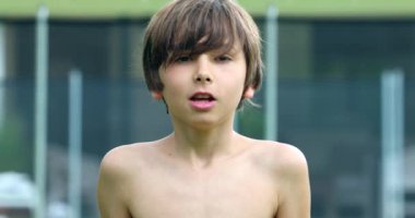 Portrait of handsome child boy smiling to camera outdoors