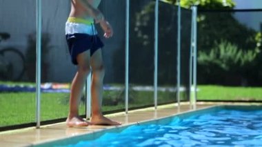 Child boy having fun at swimming pool. young boy by poolside about to jump