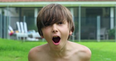 Child boy roaring screaming to camera