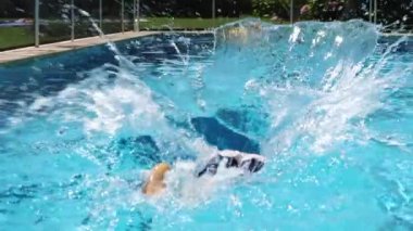 Young boy plunges inside pool water. Child plunging into water