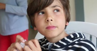 Contemplative happy portrait of young boy thinking and smiling