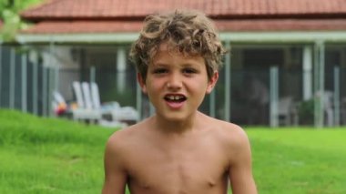 Portrait of young boy shouting in slow-motion. Child screaming from top of his lungs