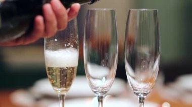 Closeup serving champagne in 120fps slow-motion