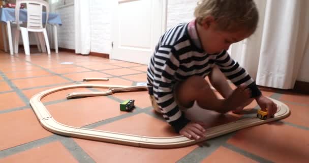 Child Boy Plays Wooden Car Toy Road Indoors Himself — Vídeo de Stock