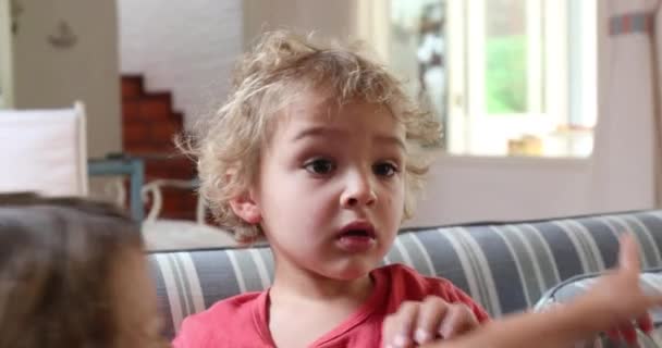 Closeup Toddler Child Seated Home Sofa Staring — Vídeo de Stock