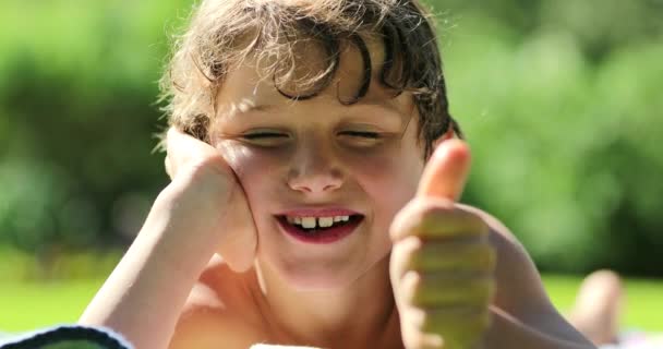 Handsome Little Boy Laid Grass Child Giving Thumb Feeling Happy — Stockvideo
