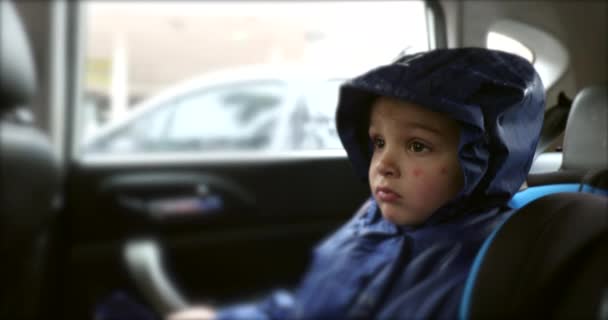 Child Back Seat Car Wearing Rain Coat — Vídeos de Stock