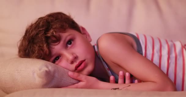 Candid Young Boy Watching Movie Laid Sofa Night Staring Screen — Wideo stockowe