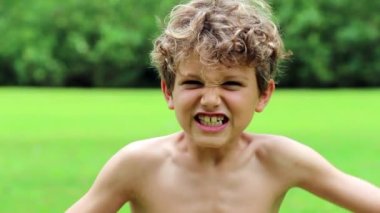 Kid screaming in ultra slow-motion. Young boy shouting and yelling